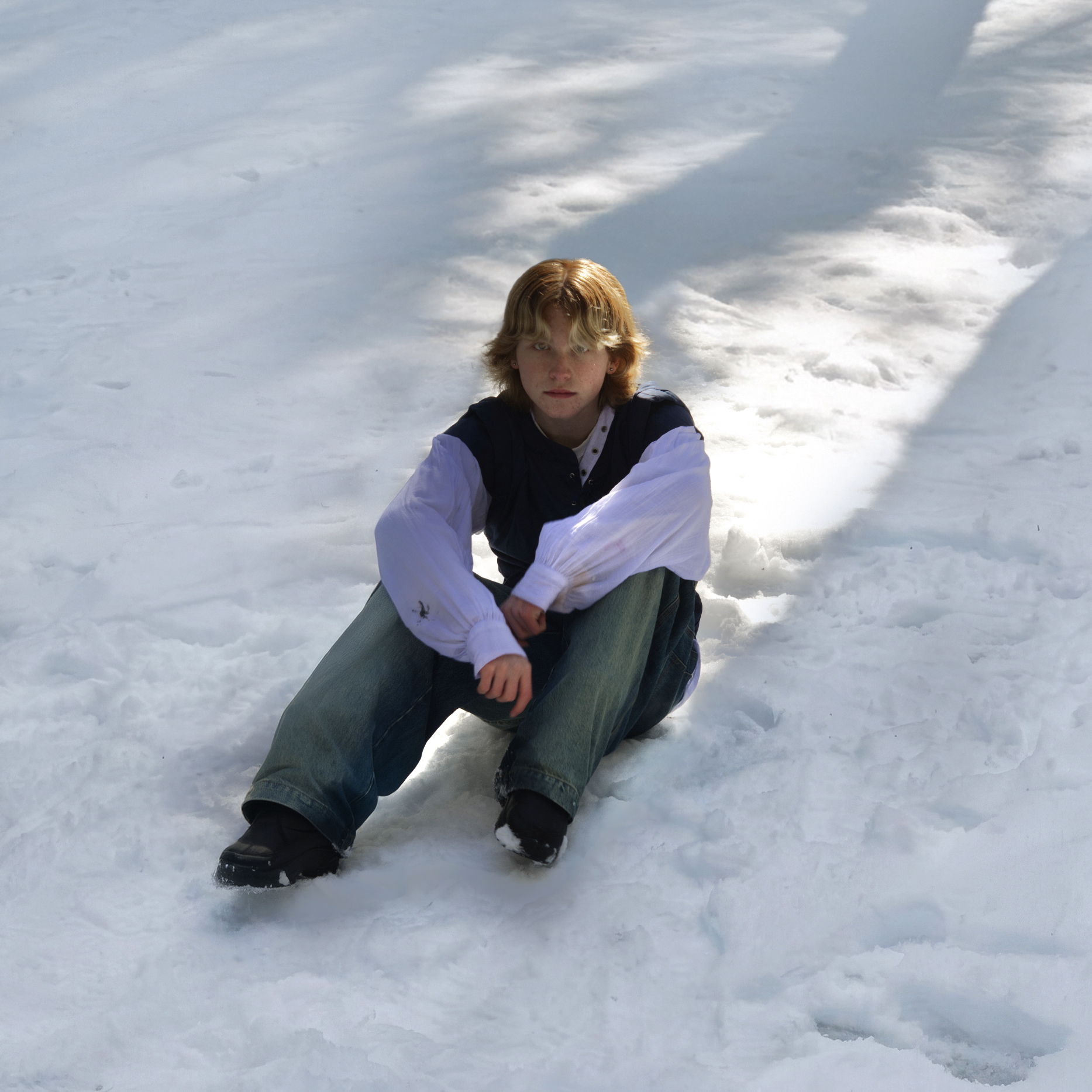 Tom Morfitt-White sitting in the snow for the Love Me Now EP artwork